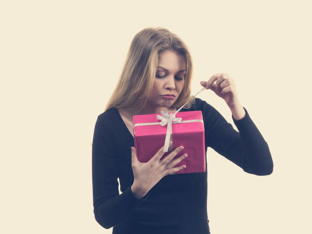 istock Girl opening pink gift box 1363586363