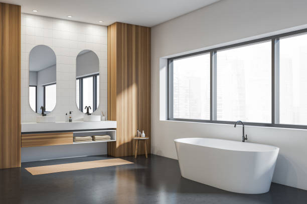 istock Light wooden bathroom interior with bathtub, sinks and panoramic window 1363587495