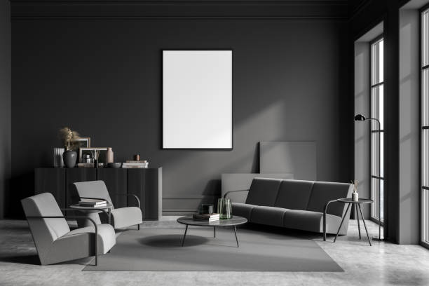 istock Dark guest room interior with sofa and armchairs, window and mockup poster 1363588101