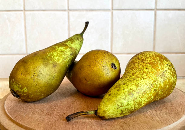 istock Green pears on a wooden surface in the kitchen close up 1363591671