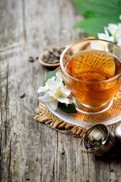 istock Jasmine and green tea in tea cup on wooden table. 1363591909