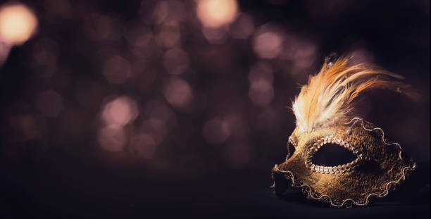 Venetian mask Golden venetian ball mask in front of the night bokeh lights. Masquerade party or holiday event celebration concept. evening ball stock pictures, royalty-free photos & images