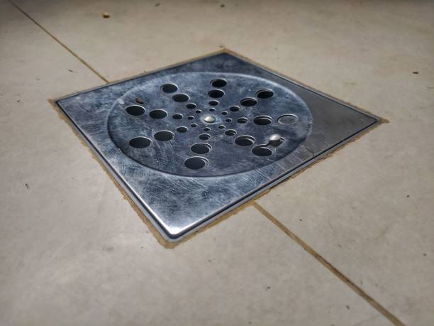 istock Open steel drain on a tiled floor 1363593888