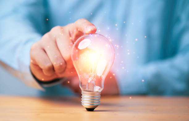 Hand touching to glowing lamp or lightbulb for creative thinking idea and problem solving or solution concept. Hand touching to glowing lamp or lightbulb for creative thinking idea and problem solving or solution concept. ideology stock pictures, royalty-free photos & images