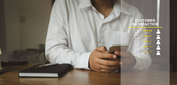 istock Hand using mobile phone with Happy icon and Five stars for service rating feedback of experience customer survey. Business annual satisfaction  concept. excellent performance. social media evaluation. 1363594384