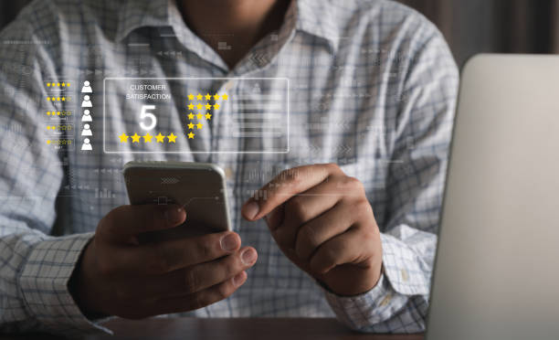 istock Hand using mobile phone with Happy icon and Five stars for service rating feedback of experience customer survey. Business annual satisfaction  concept. excellent performance. social media evaluation. 1363594385