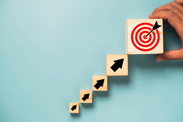 istock Hand putting virtual target board and arrow which print screen on wooden cube. Business achievement goal and objective target concept. 1363594442