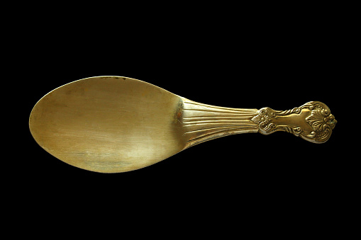 Old metal big spoon. Close-up. Isolated object on a black background. Isolate.
