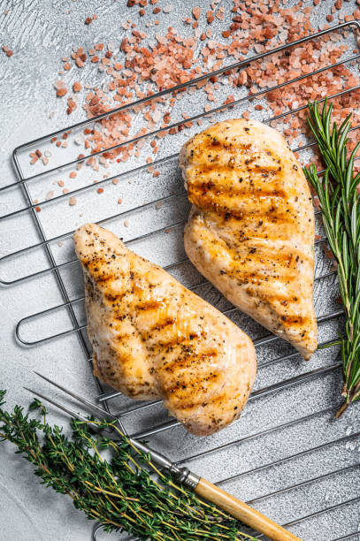 istock Grilled chicken breasts steaks cooked on a summer BBQ. Gray background. Top view 1363597674