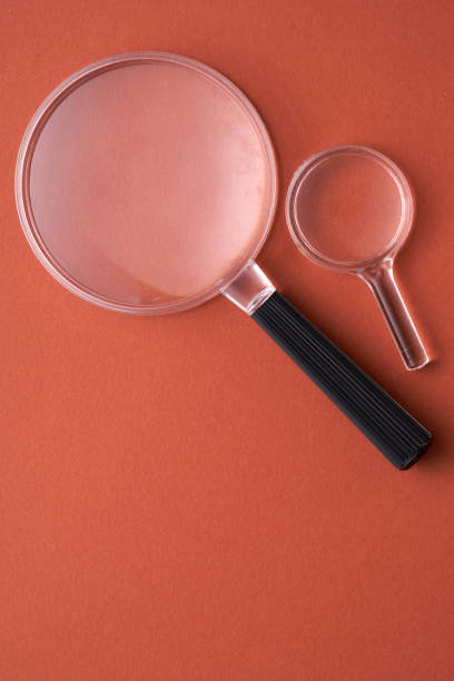 istock magnifying glass against red background 1363599336