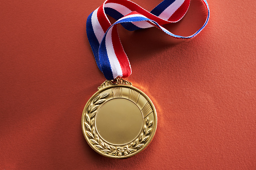 gold colored medal on red  background