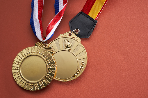 gold colored medal on red  background