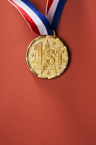 gold colored medal on red  background