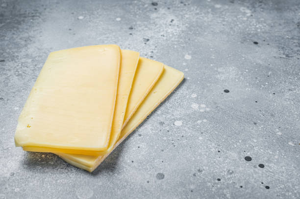 istock Uncooked Raclette Swiss cheese slices. Gray background. Top view. Copy space 1363600499
