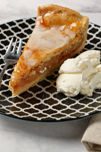 istock A slice of covered apple pie with frosting. Served on a plate. 1363600661