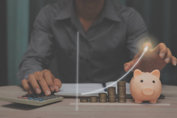 istock busoness man on working table with hand point graph growth up economic leader for success economy investment concept. 1363600847
