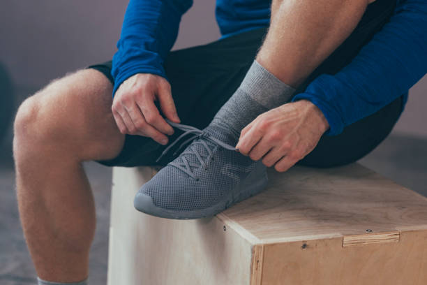 istock An Anonymous Man Tying Shoelaces on his Shoes 1363602258