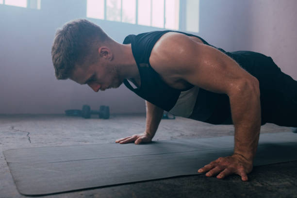 istock Serious Man Exercising in the Gym 1363602259