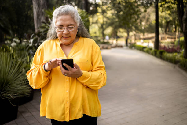 Senior woman using mobile phone stock photo