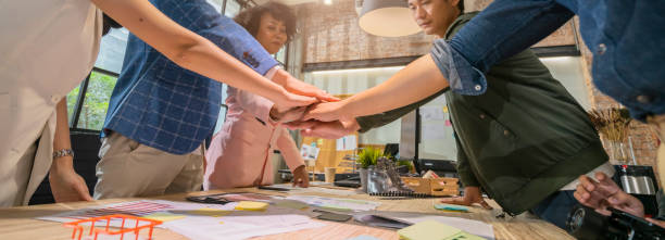 Successful hand assemble together goal achievement in office,power of successful power in brainstorm meeting office teamwork hand together in center of meeting table successful ideas concept stock photo