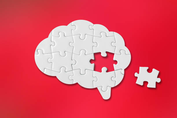 istock Brain shaped white jigsaw puzzle on red background, a missing piece of the brain puzzle, mental health and problems with memory 1363605087