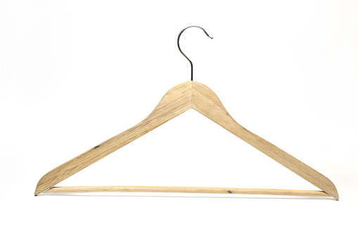 Close up of classic clothes hanger with cross bar for hanging pants made of wood on white background