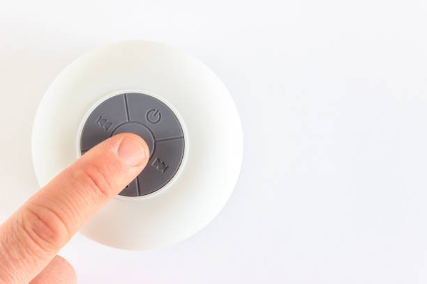 istock White circle mini speaker on isolated white background with copy space. Man finger is pressing play button. 1363609207