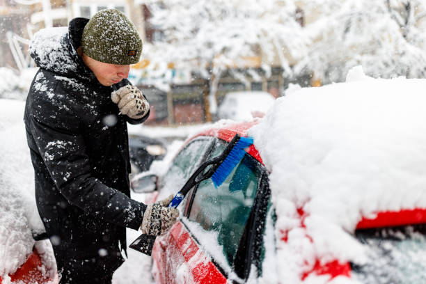 istock A Man is Cleaning a Snow From the Car with Brush. 1363612266