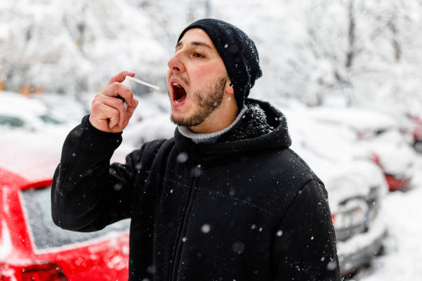 istock Young Man with Asthma is Using Inhaler During a Winter Day. 1363613761