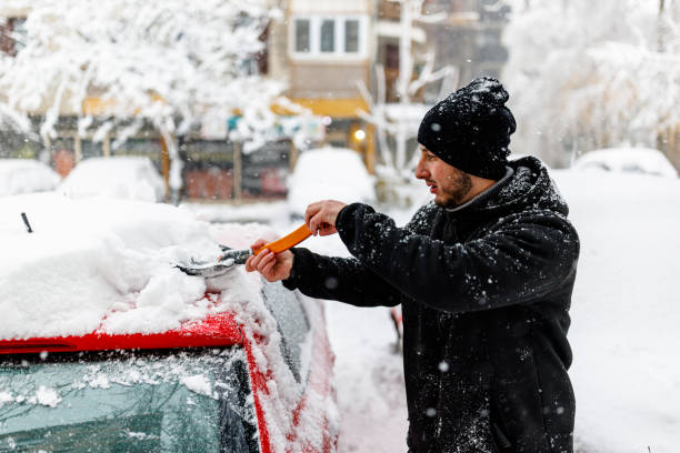 istock A Young Man is Cleaning Snow from a Car with a Shovel. 1363613878