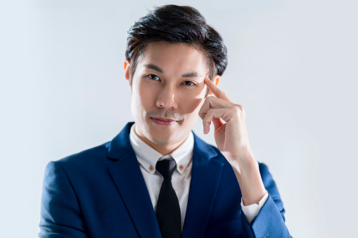 confident leadership asian mature businessman hand wear formal suit hand touch body part head thinking posture while smart smiling look at camera portrait studio shot white background