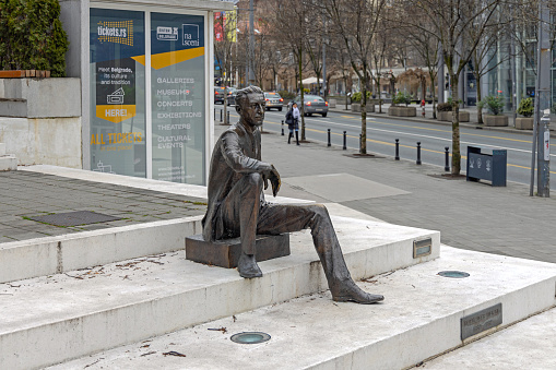 Belgrade, Serbia - January 06, 2022: Bronze Statue of Famous Writer Borislav Pekic Sitting at Cvetni Square Stairs in City Centre.