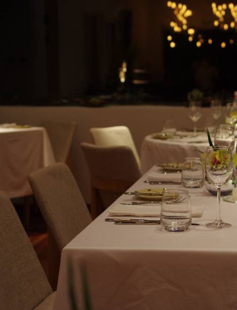 istock Empty drinking glass wineglasses and stainless steel tableware on white tablecloth with napkin at fine dining restaurant 1363616677