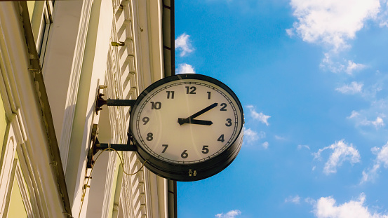 Street clock on the wall of the building