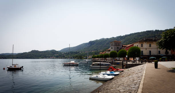 Stresa, Italy - October 5, 2024: Fishing boats moored near the shore in the Isola dei Pescatori ( Fishermen's Island).