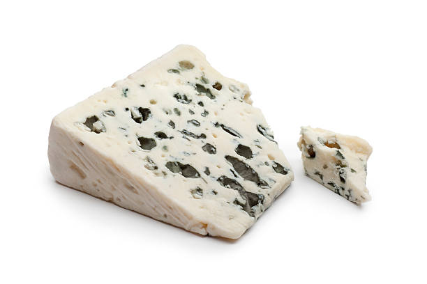 Slice of Roquefort cheese Slice of Roquefort cheese on white background roquefort cheese stock pictures, royalty-free photos & images