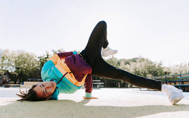 istock Cool asian young man breakdancing outdoors 1363620654