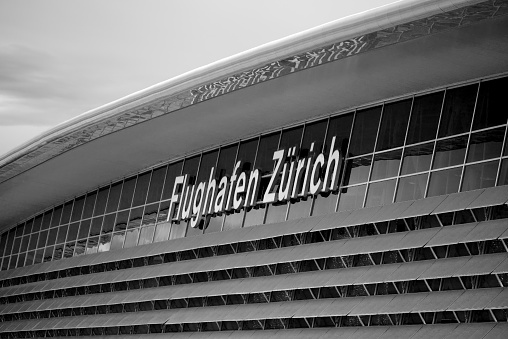 Glass facade of modern terminal building named Airside Center with lettering Zürich Airport. Photo taken January 2nd, 2022, Zurich, Switzerland.