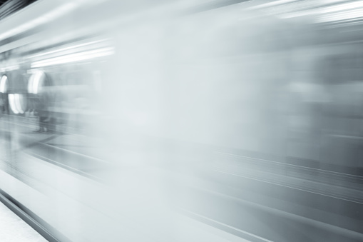 Motion blur of subway train in black and white. High speed metro in subway station.