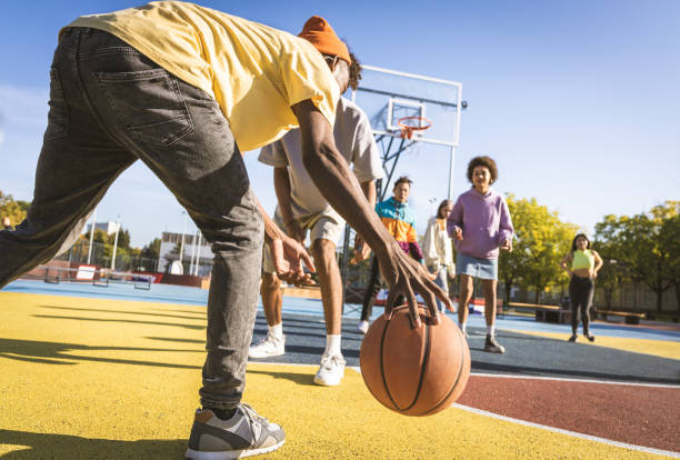 multiracial group of young friends bonding outdoors - child basketball sport education imagens e fotografias de stock