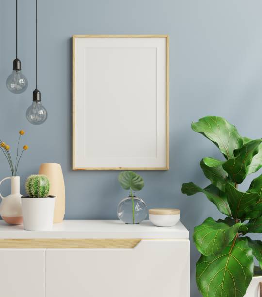 istock Mockup poster frame in minimalist interior background with dark blue wall. 1363625948