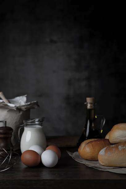 Bread and olive oil with milk and eggs with a dark background