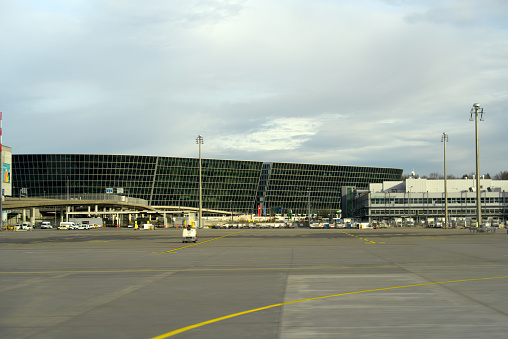 Zurich Airport with modern shopping and business building named The Circle with cloudy winter sky in the background. Photo taken January 2nd, 2022, Zurich, Switzerland.