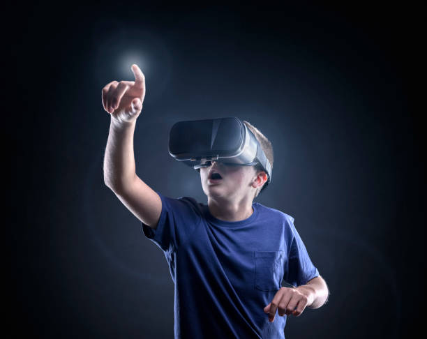 Boy experiencing using a virtual reality headset Boy experiencing using a virtual reality headset trying to touch something virtual reality point of view photos stock pictures, royalty-free photos & images