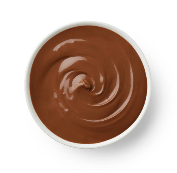istock Bowl of melted milk chocolate isolated on white background 1363627730