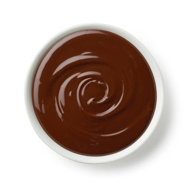 istock Bowl of melted dark chocolate isolated on white background 1363627755