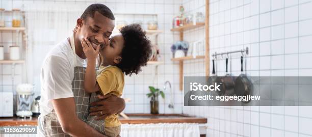 Happy African American Father And His Son At Kitchen Loving Black Little Boy Embracing And Kiss His Dad Banner Panoramic Stock Photo - Download Image Now