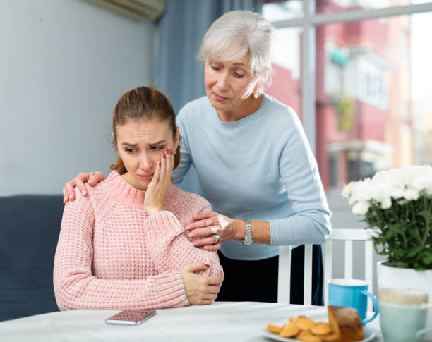 istock Senior mother encouraging her upset daughter 1363632321