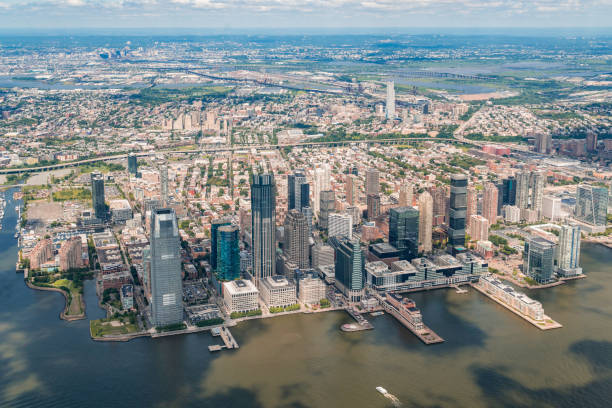 Aerial panoramic city view of New Jersey City financial Downtown skyscrapers. Bird's eye view from helicopter. Jersey city is an important transportation center for the Port of New York and New Jersey Aerial panoramic city view of New Jersey City financial Downtown skyscrapers. Bird's eye view from helicopter. Jersey city is an important transportation center for the Port of New York and New Jersey jersey city stock pictures, royalty-free photos & images