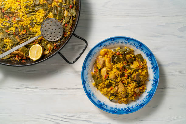 Savor a vibrant traditional Valencian paella with chicken and fresh veggies.